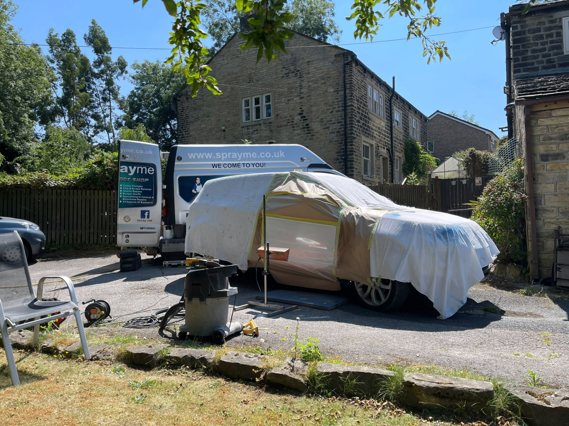Vehicle masked and prepped for on-site spray work